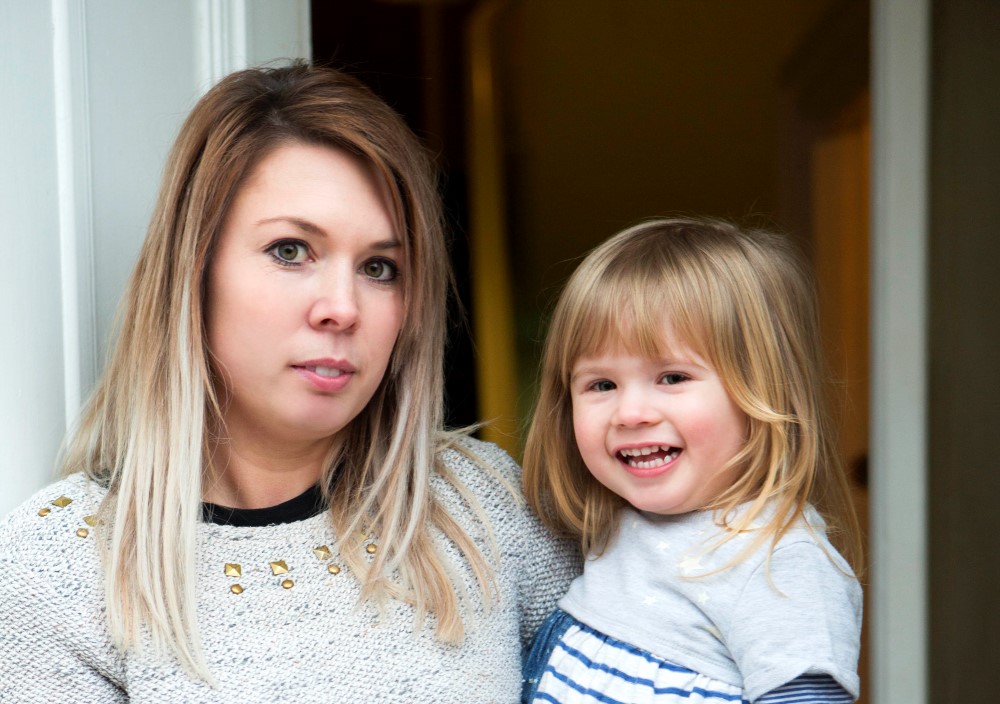 Image of a lady holding her baby